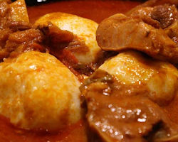 Omotuo with choice of Peanut Butter Soup, Palm Soup, and choice of meat.